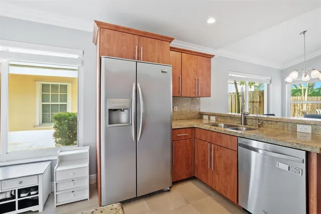 a kitchen with a refrigerator sink and cabinets
