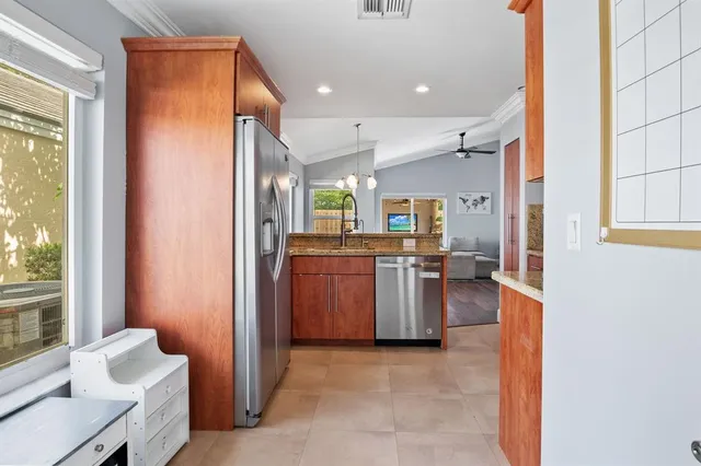 a view of a kitchen with a refrigerator and a sink