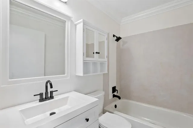 a bathroom with a bathtub a sink and mirror