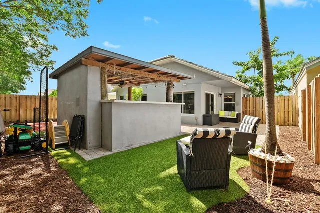 a backyard of a house with outdoor seating