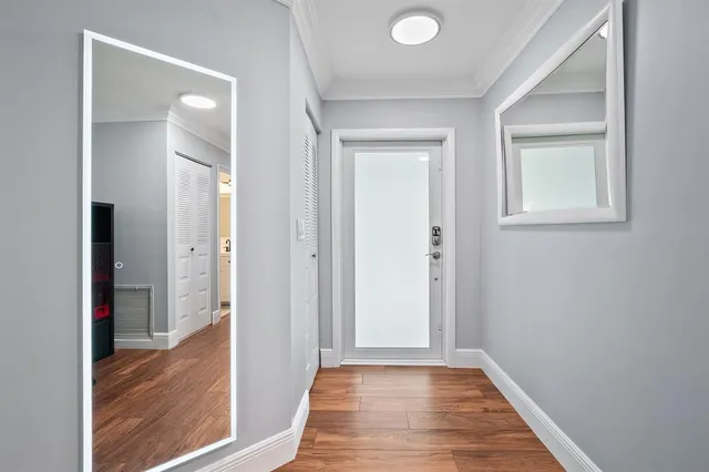 a view of a hallway with wooden floor