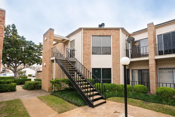 a front view of a house with wooden stairs