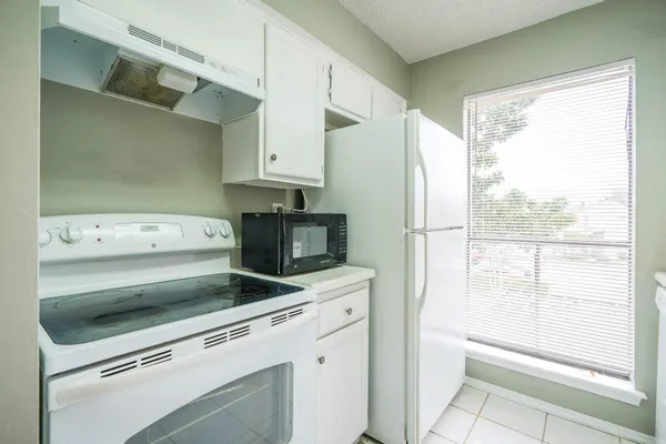 a view of kitchen with wooden floor washer and dryer