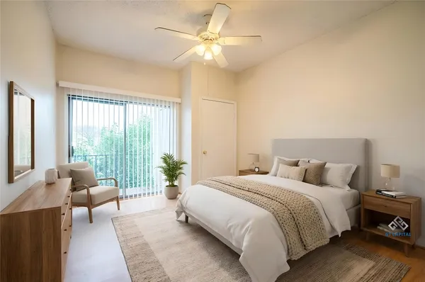 a spacious bedroom with a bed and a couch next to a window