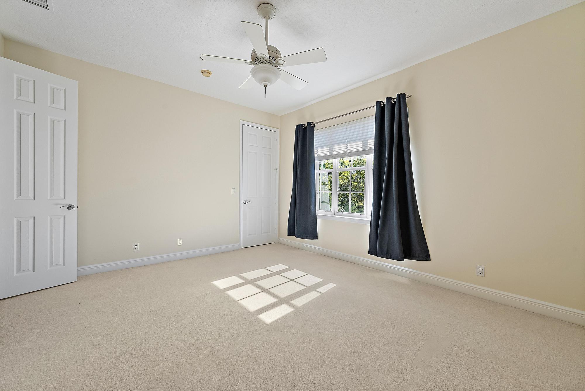 141 Morning Dew Circle Jupiter, FL 33458 - Photo 11 of 22 an empty room with windows and fan