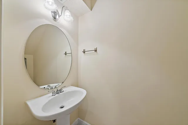 a bathroom with a sink and mirror