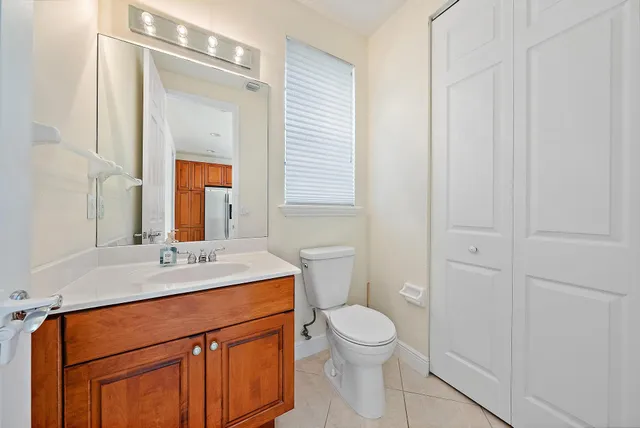 a bathroom with a sink a toilet and a mirror