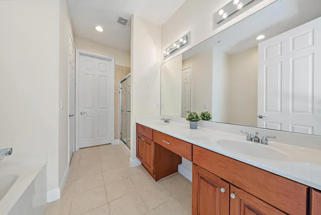 a spacious bathroom with a double vanity sink mirror and double