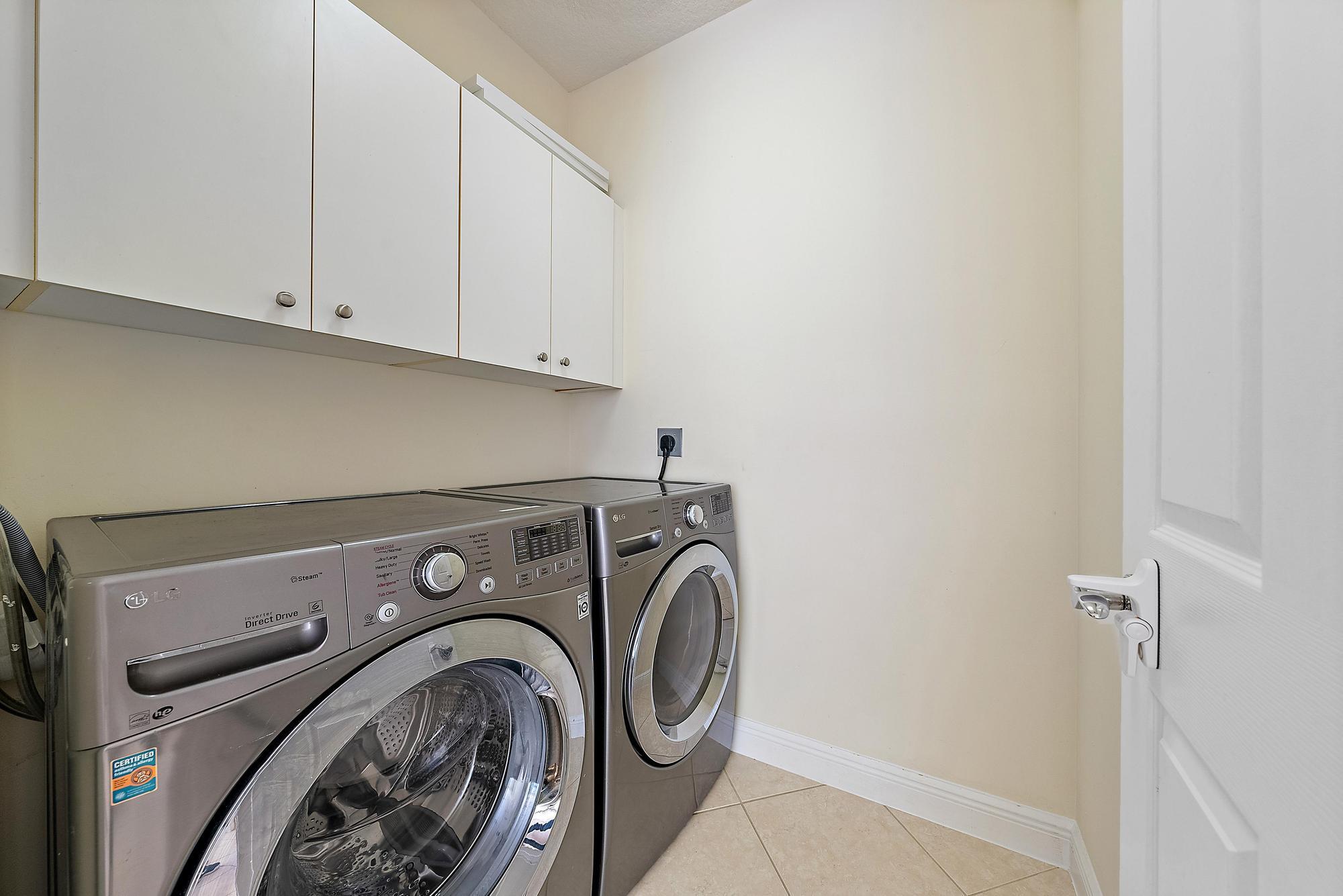 141 Morning Dew Circle Jupiter, FL 33458 - Photo 19 of 22 a utility room with dryer and washer