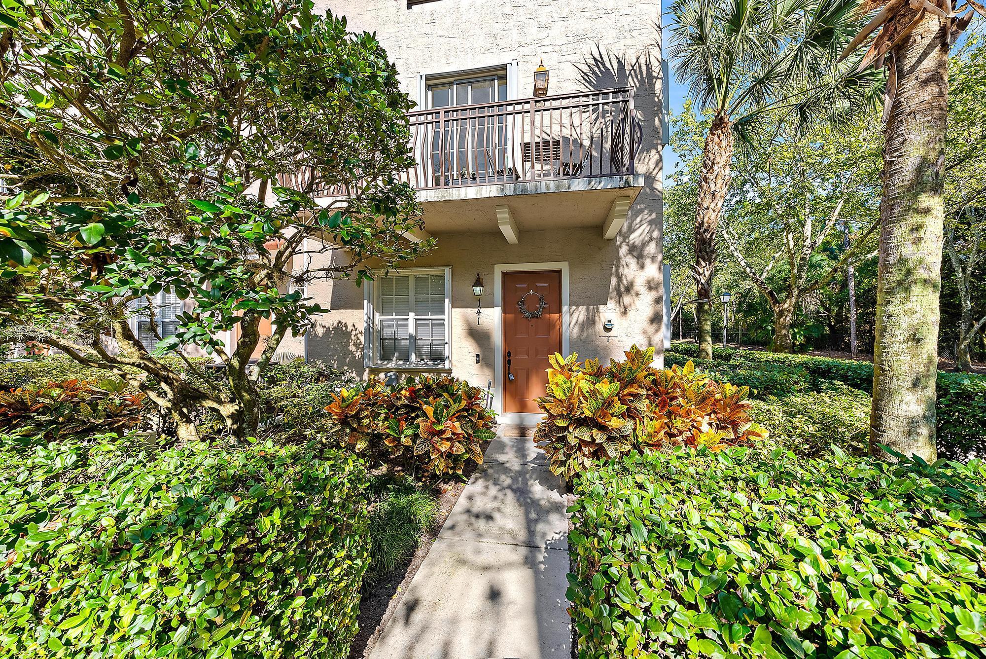 141 Morning Dew Circle Jupiter, FL 33458 - Photo 2 of 22 a front view of a house with a yard
