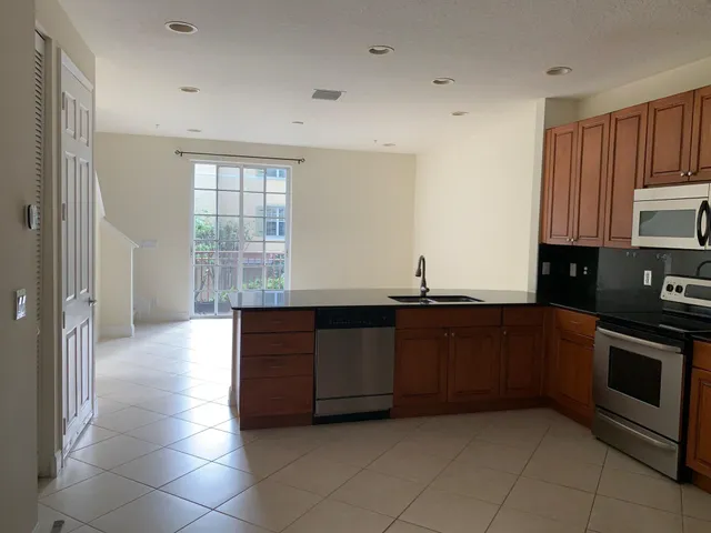 a kitchen with stainless steel appliances granite countertop a stove and a sink