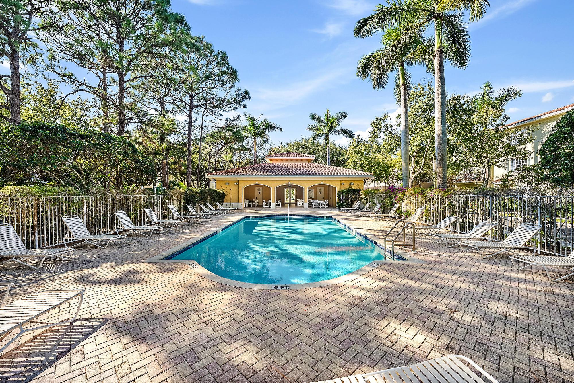 141 Morning Dew Circle Jupiter, FL 33458 - Photo 22 of 22 a front view of a house with garden