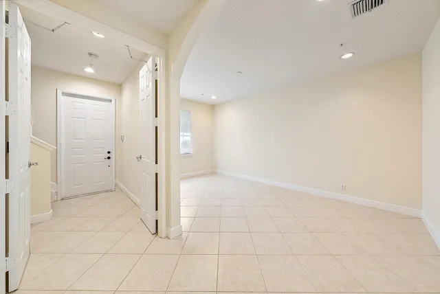 an empty room with white cabinet and shower