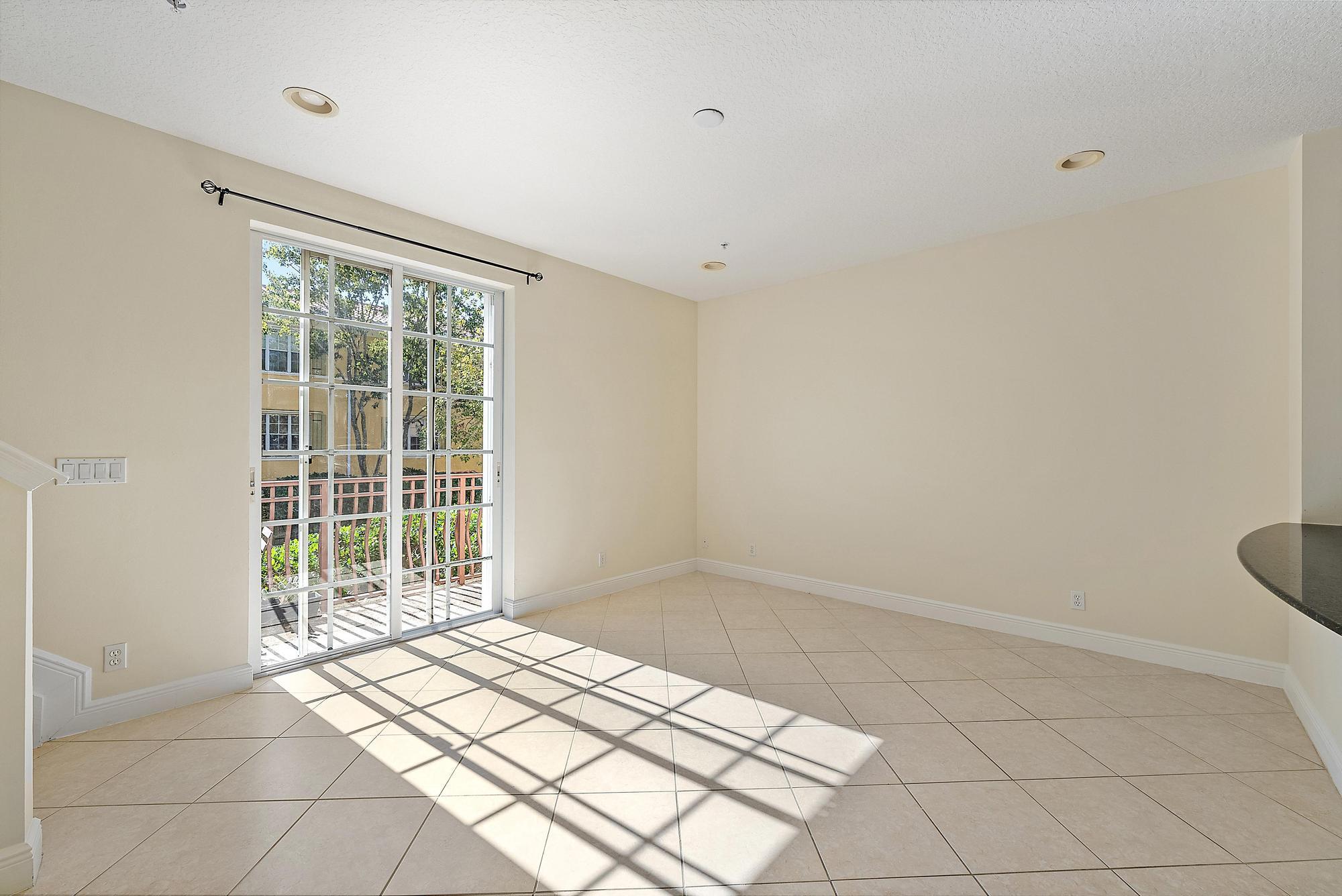 141 Morning Dew Circle Jupiter, FL 33458 - Photo 7 of 22 a view of empty room with wooden floor and fan