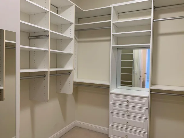 a view of walk in closet with empty racks