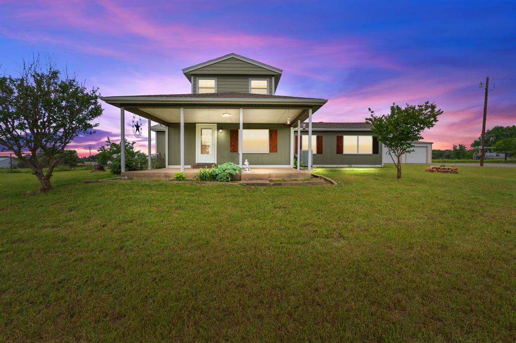 View of front facade with a front yard and a porch