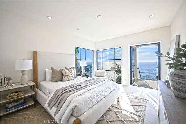 a view of a swimming pool with couches and wooden floor