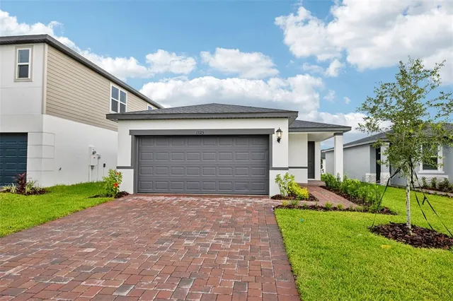 a front view of house with yard and green space