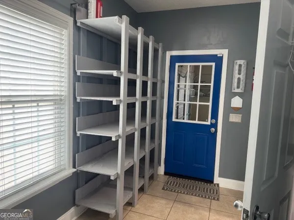 a bathroom with a toilet a sink and wooden floor