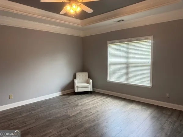an empty room with a chandelier fan