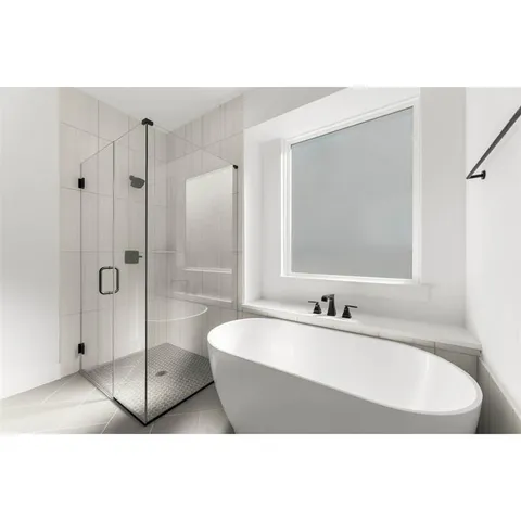 a bathroom with a tub a sink and a shower