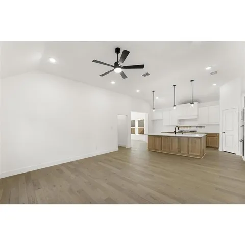 a view of a kitchen with kitchen island and stainless steel appliances