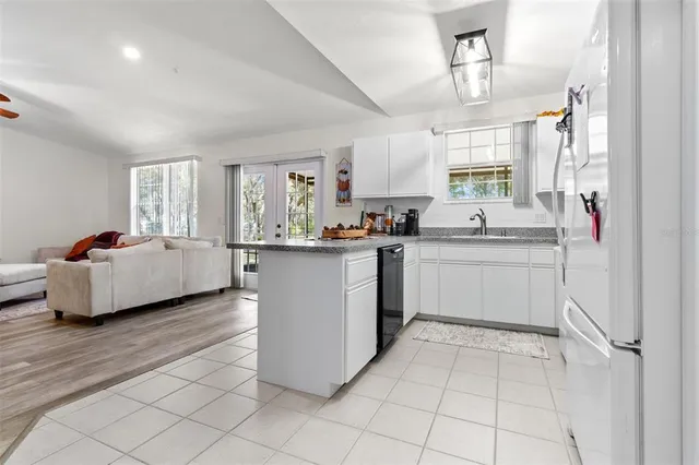 a kitchen with a sink a window and cabinets