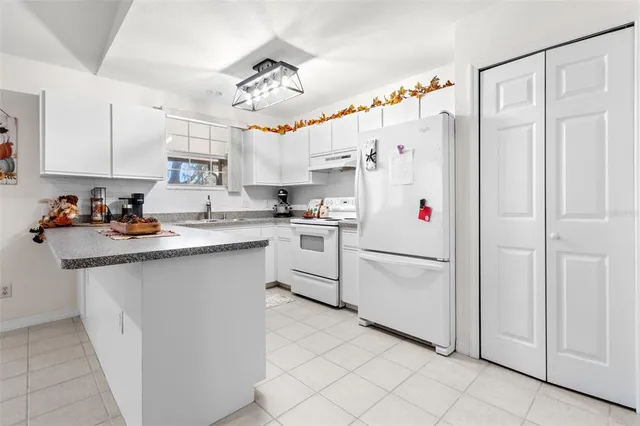 a white refrigerator freezer sitting in a kitchen