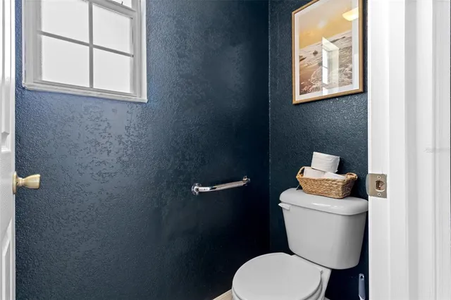 a white toilet sitting next to a bathroom sink