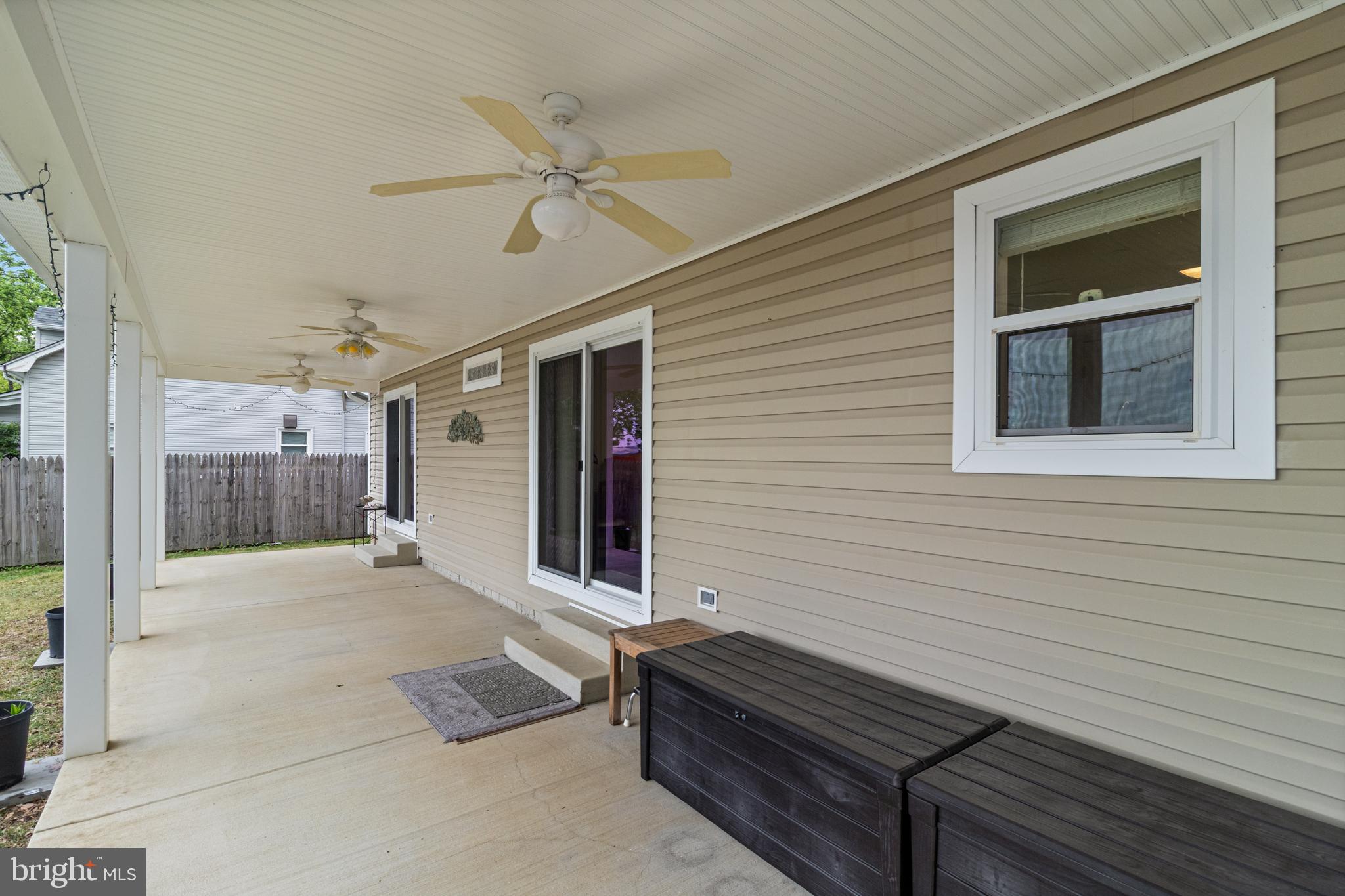 12015 Woodbury Road Nanjemoy, MD 20662 - Photo 7 of 53 a view of a balcony with two chairs and a ceiling fan