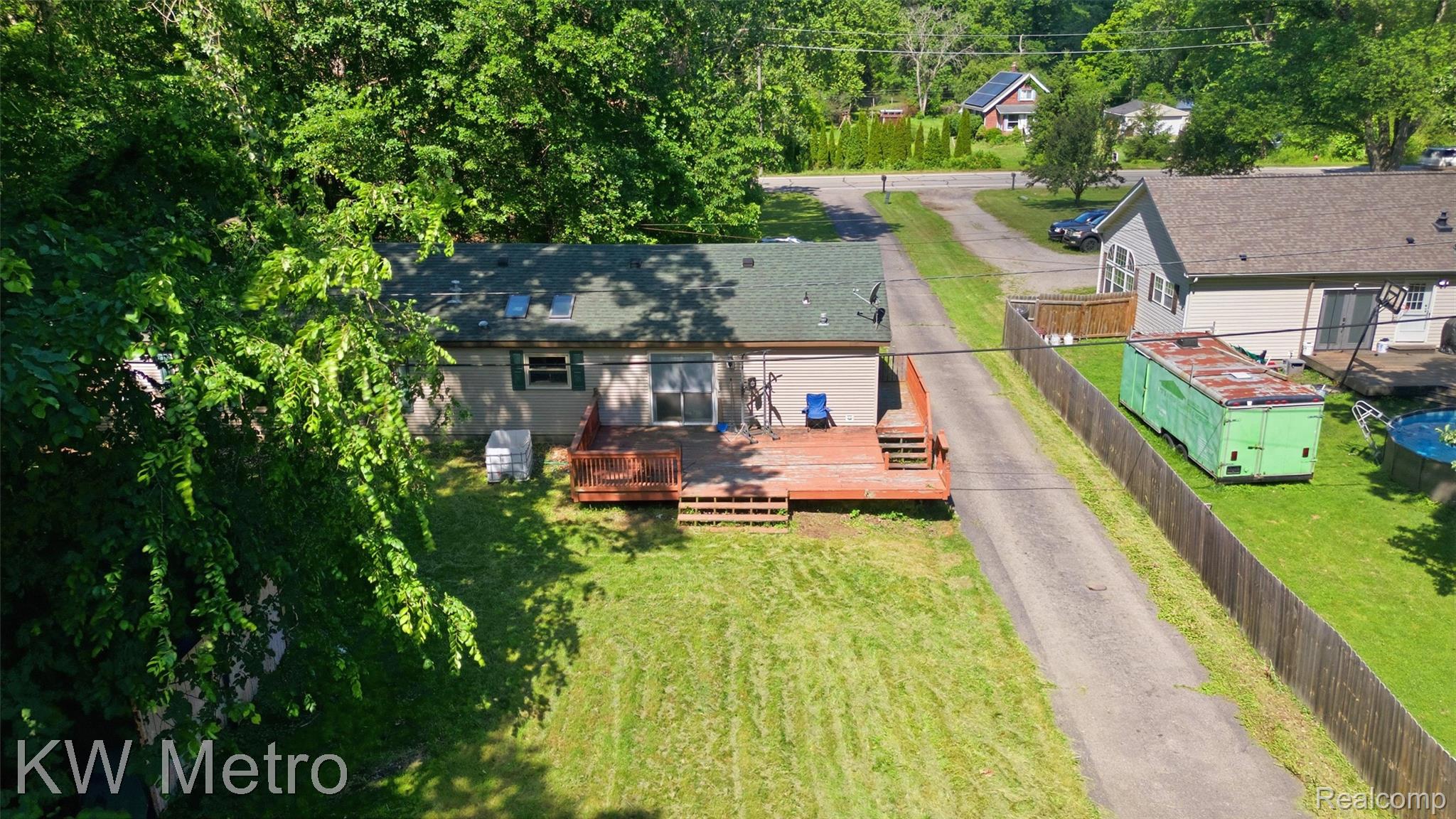 22733 Sumpter Road Belleville, MI 48111 - Photo 44 of 52 Single-story residence featuring a durable green shingle roof with skylights, siding exterior, and a spacious wooden deck