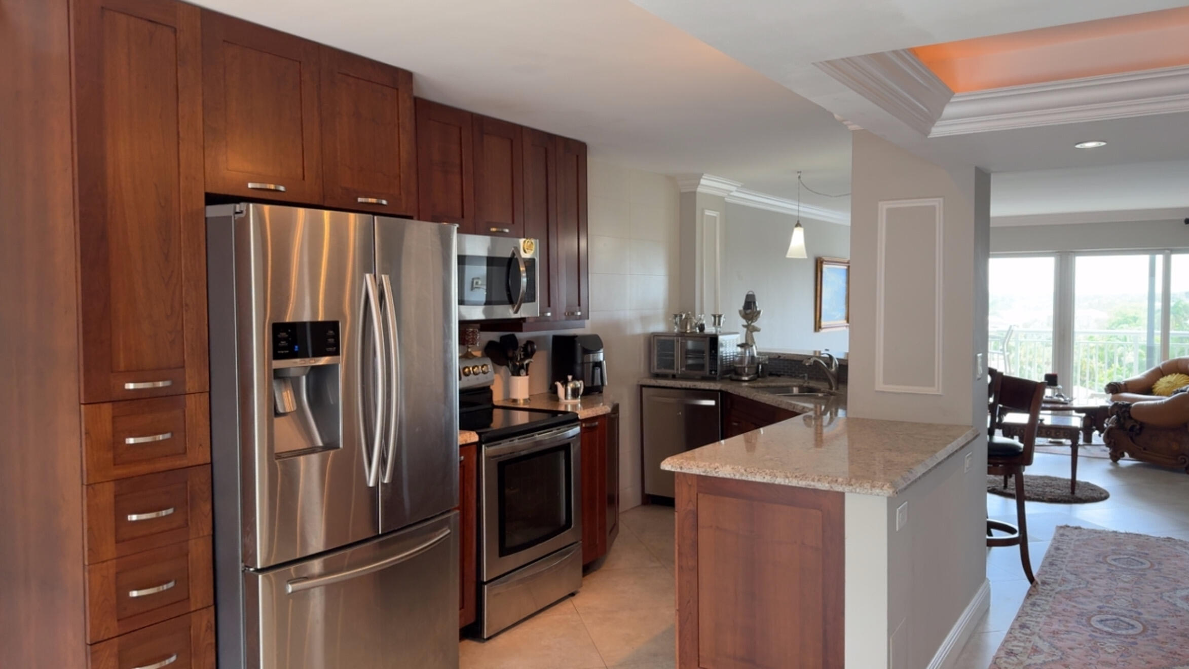 2611 North Riverside Drive, Unit 703 Pompano Beach, FL 33062 - Photo 27 of 81 a kitchen with stainless steel appliances a refrigerator and a stove top oven