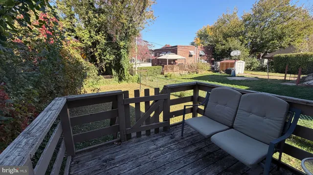 a view of an outdoor sitting area with wooden furniture