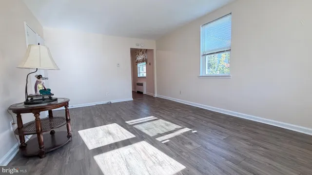 a view of workspace with wooden floor and a window