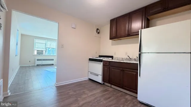a kitchen with a refrigerator and a stove