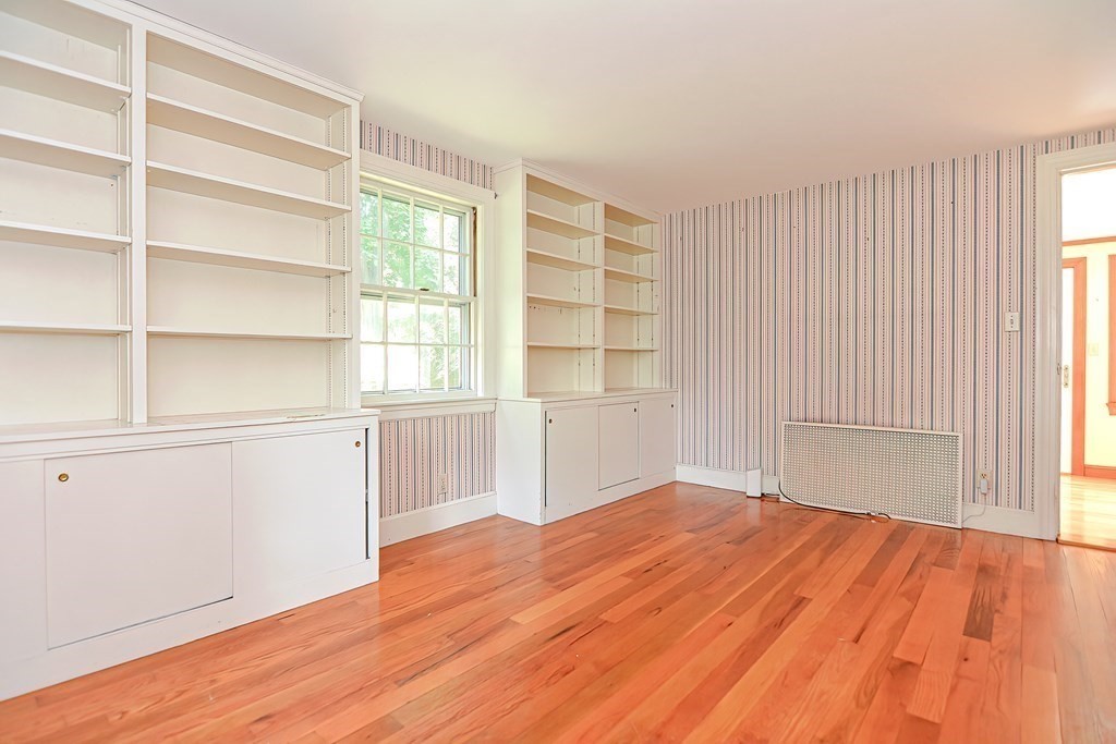 38 Hidden Road Andover, MA 01810 - Photo 11 of 31 a view of empty room with wooden floor and fan