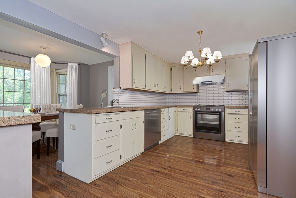 38 Hidden Road Andover, MA 01810 - Photo 4 of 31 a kitchen with stainless steel appliances a stove refrigerator and cabinets