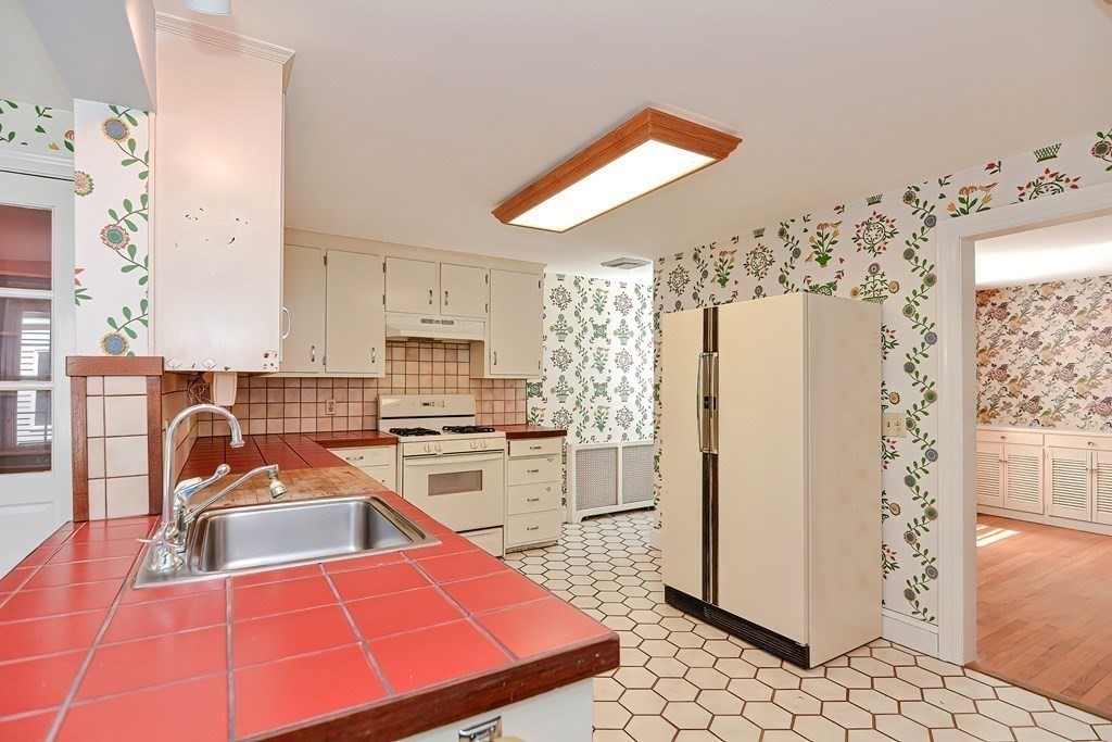 38 Hidden Road Andover, MA 01810 - Photo 5 of 31 a kitchen with refrigerator a stove a sink a counter top space and cabinets