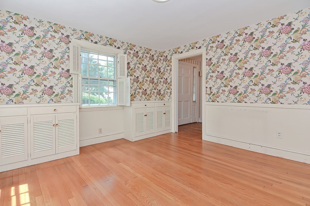 38 Hidden Road Andover, MA 01810 - Photo 8 of 31 an empty room with wooden floor and windows