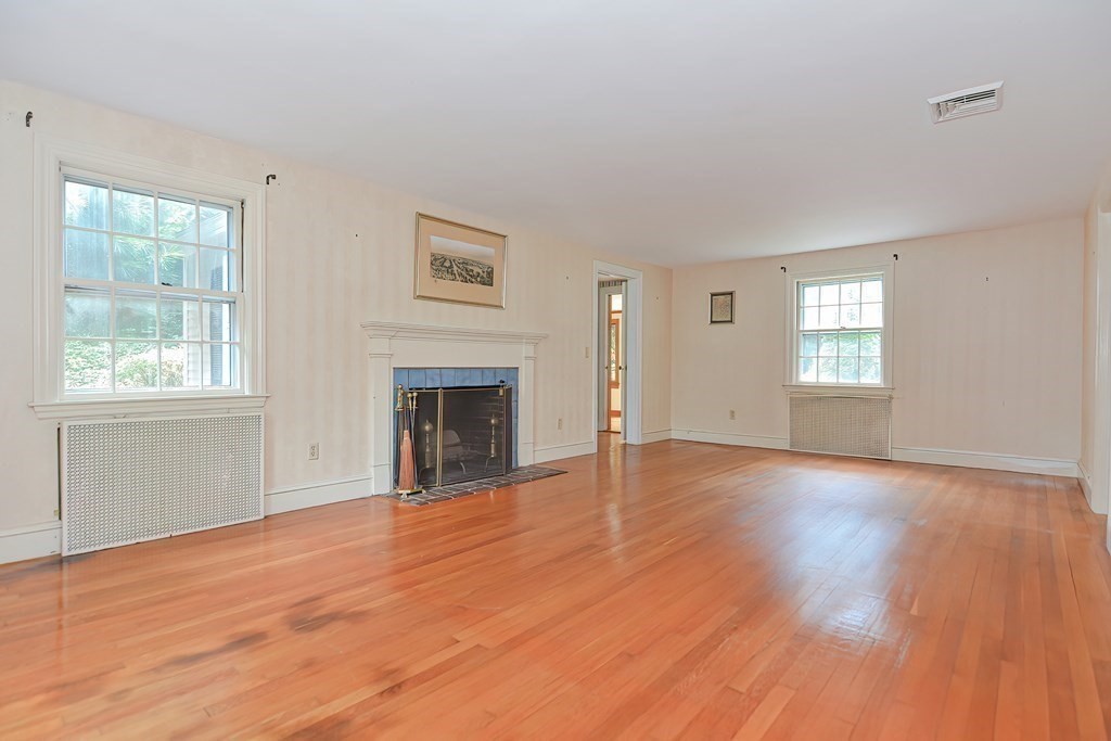 38 Hidden Road Andover, MA 01810 - Photo 10 of 31 a view of an empty room with window and wooden floor