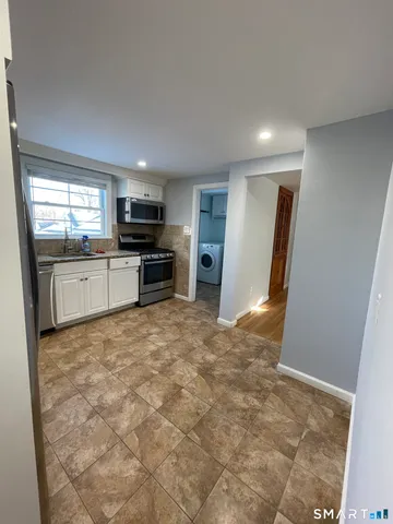 a large kitchen with a stove a refrigerator and a sink