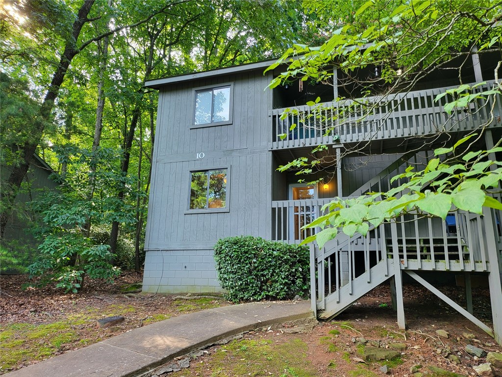 150 Ligon Street, Unit 1001 Clemson, SC 29631 - Photo 1 of 29 Wooded lot surrounds this multi-level unit, featuring inviting stairs leading to upper balconies.