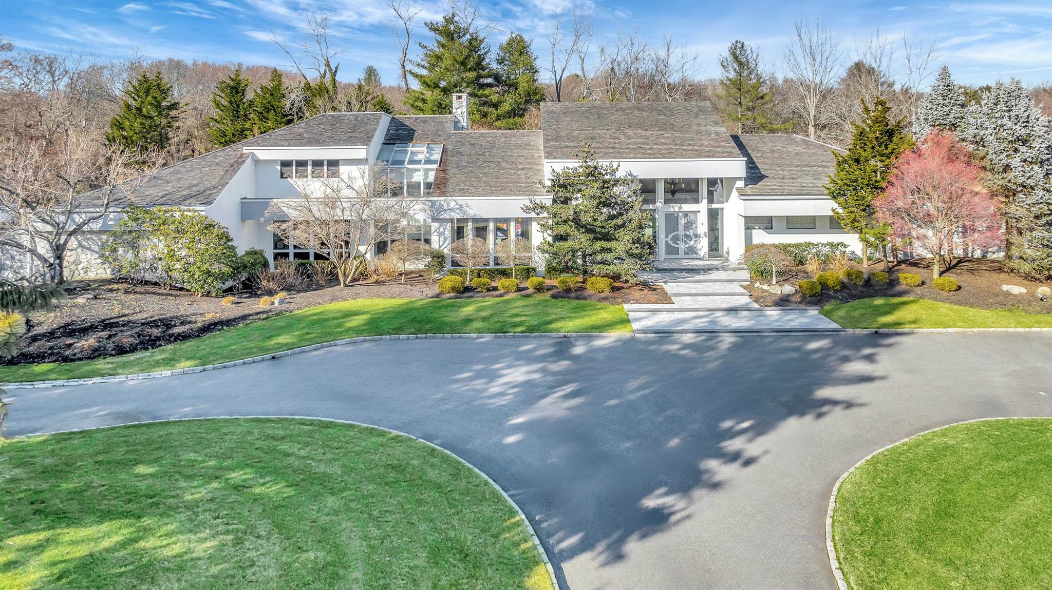 1 Meadow Gate Road East Head of the Harbor, NY 11780 - Photo 1 of 1 a front view of a house with a yard and trees