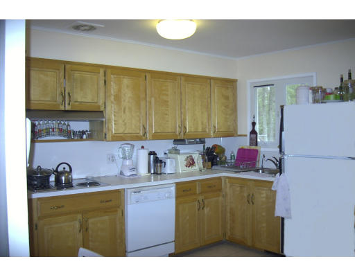 10 Pamela Road Framingham, MA 01701 - Photo 3 of 9 a kitchen with a sink a refrigerator and cabinets