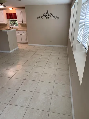 a view of a kitchen with cabinets and wooden floor