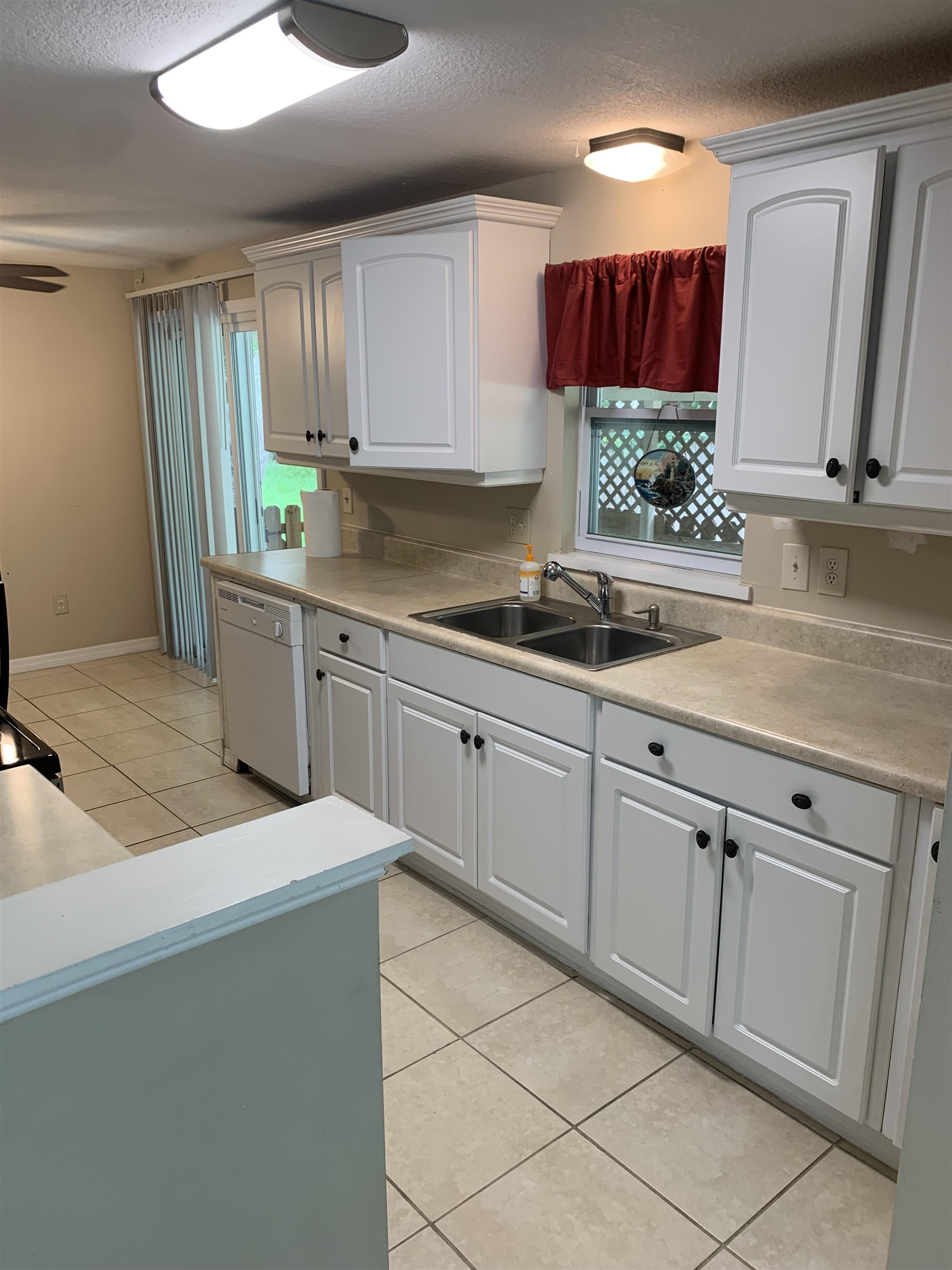 916 Palermo Road St. Augustine, FL 32086 - Photo 7 of 21 a kitchen with white cabinets a sink and dishwasher
