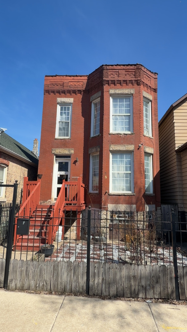 10045 South Ave M Chicago, IL 60617 - Photo 1 of 25 a front view of a house with glass windows