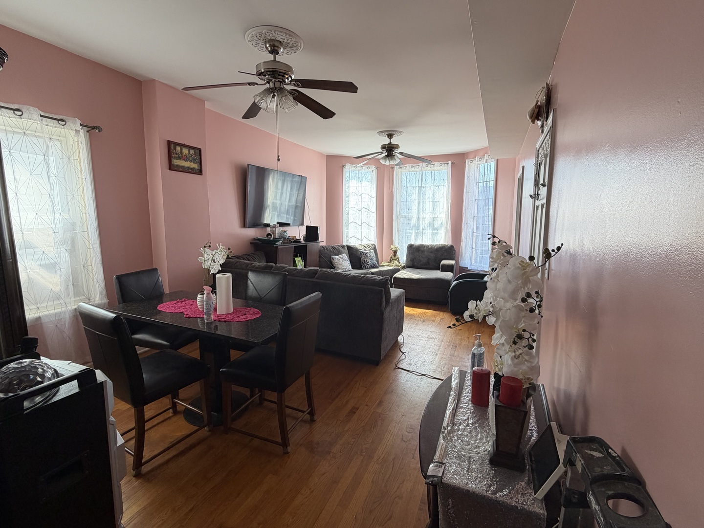 10045 South Ave M Chicago, IL 60617 - Photo 6 of 25 a living room with furniture a window and a flat screen tv