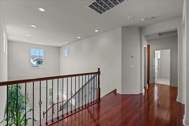 a view of hallway with wooden floor