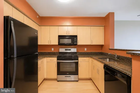 a kitchen with a sink and a refrigerator